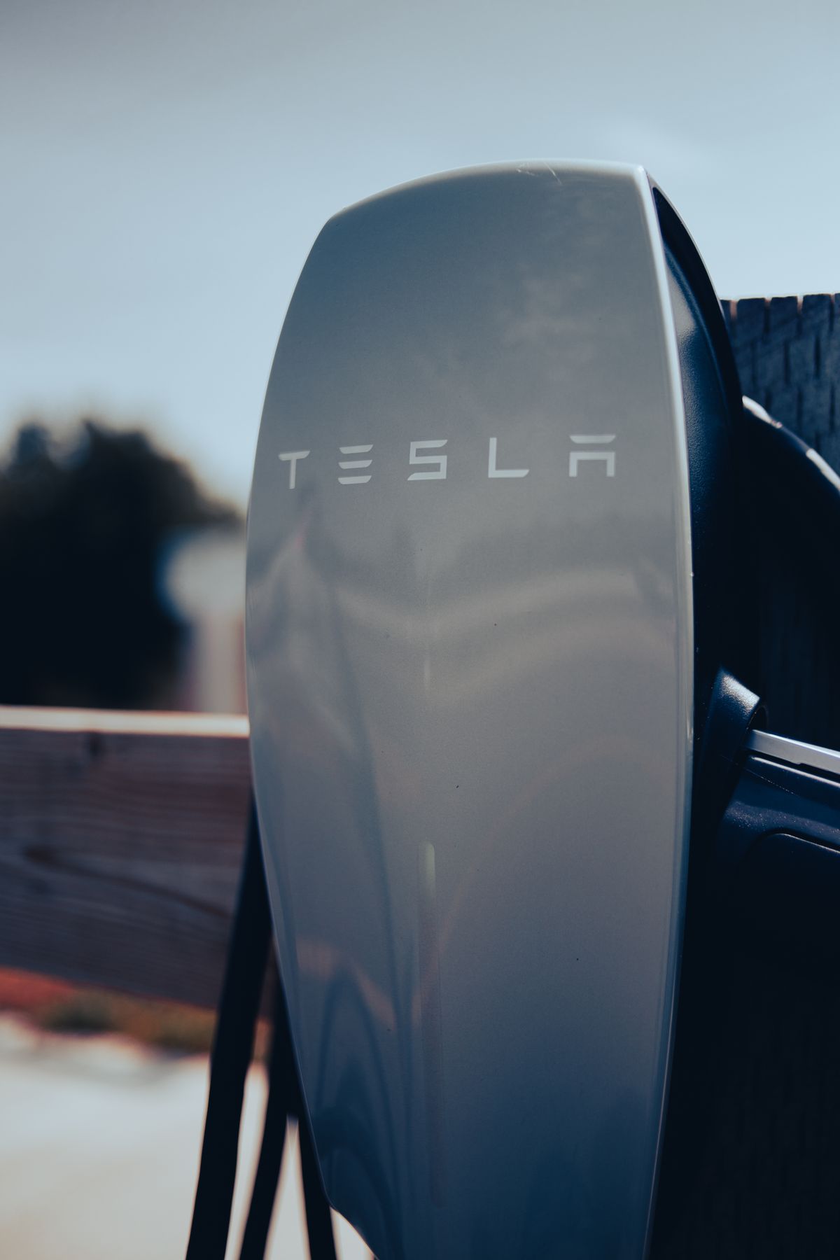 Close-up of an EV charging connector plugged into a car